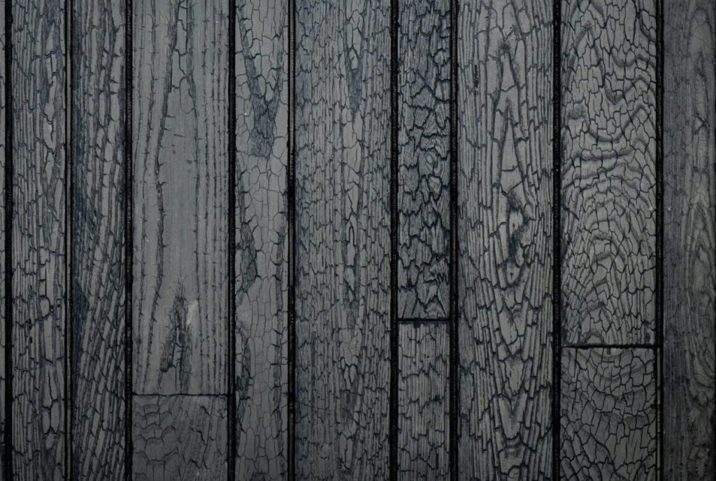 Close-up of vertically aligned charred wood planks showing distinctive crackled texture patterns