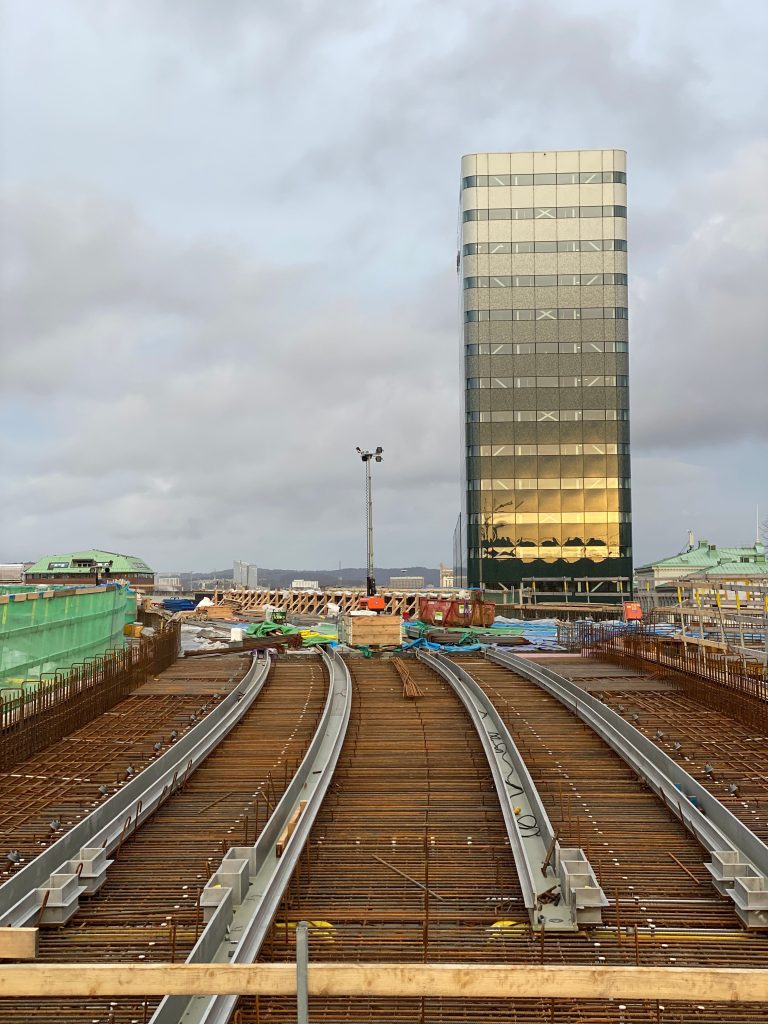 Construction site adjacent to high-rise building - structural analysis software like ETABS and SAP2000 designs these structures
