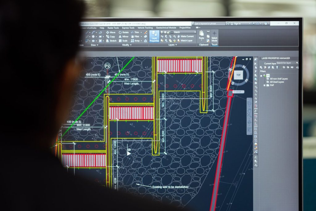 Architect reviewing building information modeling BIM 3D model on screen for 2026 construction project